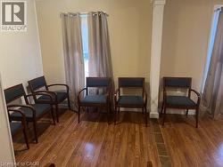 Sitting room featuring dark wood-style flooring and baseboards - 