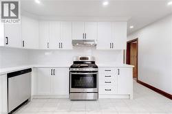 Kitchen w/ Stainless Steel Appliances & Built-in Cabinet - 
