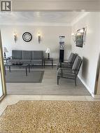 Living area featuring light wood-style floors and crown molding - 