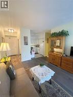 Living room with dark wood-type flooring and ceiling fan - 