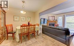 Dining area featuring a tile fireplace and light tile patterned flooring - 