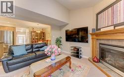 Living room featuring a fireplace and light carpet - 