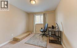 Office featuring light carpet and baseboards - 