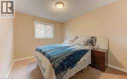 Bedroom featuring light carpet and a textured ceiling - 