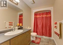 Bathroom featuring vanity, a textured ceiling, light tile patterned flooring, and shower / tub combo - 