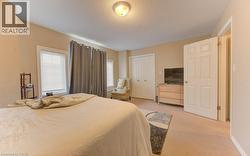 Bedroom with light colored carpet, a closet, and a textured ceiling - 