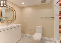 Full bathroom featuring curtained shower, light tile patterned flooring, vanity, and recessed lighting - 