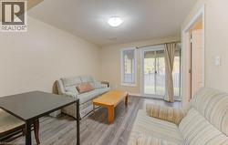 Living area featuring light wood finished floors and a textured ceiling - 