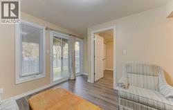 Sitting room featuring wood finished floors and baseboards - 