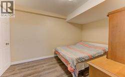 Bedroom featuring wood finished floors and a textured ceiling - 
