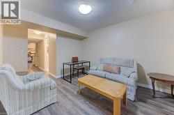 Living area featuring wood finished floors and a textured ceiling - 