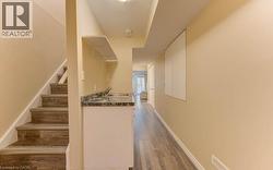 Stairway with wood finished floors and baseboards - 