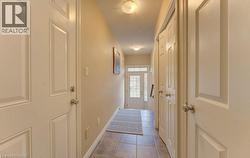 Hallway featuring dark tile patterned floors and a textured ceiling - 
