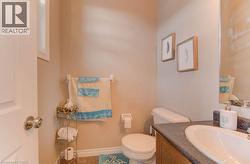 Half bathroom featuring vanity and tile patterned flooring - 