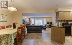 Dining space featuring a glass covered fireplace, light tile patterned floors, and a textured ceiling - 