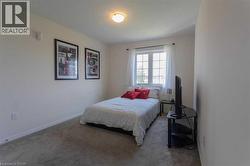 Carpeted bedroom featuring baseboards - 