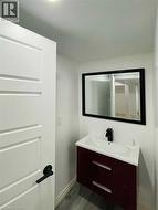 Bathroom featuring vanity and dark wood-type flooring - 