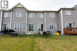 Back of property featuring a lawn and a deck - 