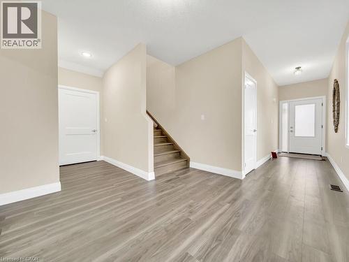 Unfurnished living room featuring light wood finished floors and stairs - 256 W King Street, Ingersoll, ON - Indoor Photo Showing Other Room