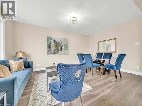 Living room featuring light wood-style floors and a textured ceiling - 256 W King Street, Ingersoll, ON - Indoor