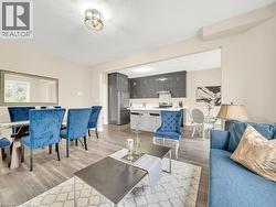 Living room with light wood-type flooring and a textured ceiling - 