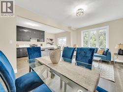 Dining room featuring light wood finished floors and a textured ceiling - 