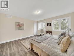 Bedroom with wood finished floors and baseboards - 