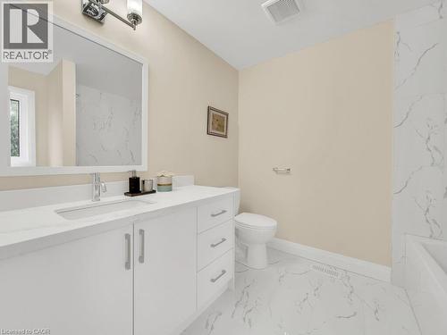 Bathroom with vanity, light marble finish flooring, and a combined bath / shower with marble appearance - 256 W King Street, Ingersoll, ON - Indoor Photo Showing Bathroom