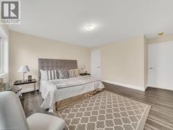 Bedroom with baseboards and wood finished floors - 