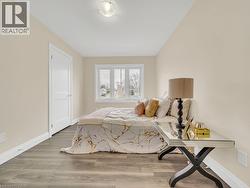 Bedroom with baseboards and wood finished floors - 