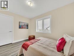 Bedroom with wood finished floors and a textured ceiling - 