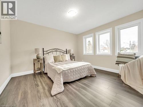 Bedroom featuring wood finished floors and a textured ceiling - 256 W King Street, Ingersoll, ON - Indoor Photo Showing Bedroom
