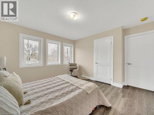 Bedroom with wood finished floors and a textured ceiling - 256 W King Street, Ingersoll, ON - Indoor Photo Showing Bedroom