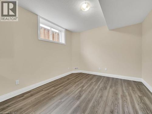 Basement with a textured ceiling and light wood finished floors - 256 W King Street, Ingersoll, ON - Indoor Photo Showing Other Room