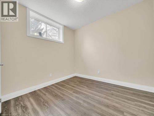 Empty room featuring a textured ceiling and wood finished floors - 256 W King Street, Ingersoll, ON - Indoor Photo Showing Other Room