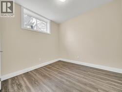 Empty room featuring a textured ceiling and wood finished floors - 