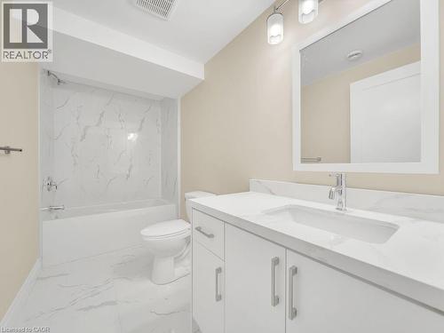 Full bath featuring vanity, light marble finish floors, and tub / shower combination - 256 W King Street, Ingersoll, ON - Indoor Photo Showing Bathroom