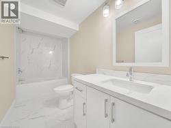 Full bath featuring vanity, light marble finish floors, and tub / shower combination - 