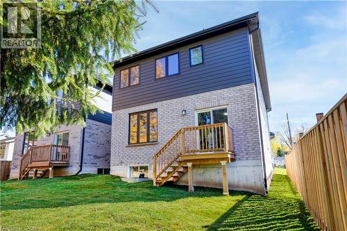 Rear view of property featuring stairs, brick siding, and a deck - 256 W King Street, Ingersoll, ON - Outdoor With Deck Patio Veranda