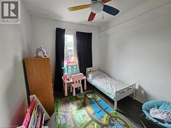 Bedroom with wood finished floors and a ceiling fan - 