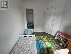 Playroom featuring dark wood-type flooring and baseboards - 