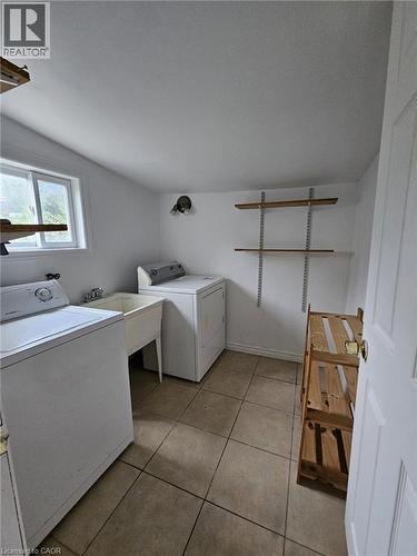 Washroom featuring light tile patterned floors and washer and dryer - 253 Mary Street, Hamilton, ON - Indoor Photo Showing Laundry Room