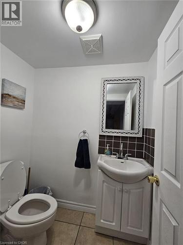 Half bathroom with vanity and light tile patterned floors - 253 Mary Street, Hamilton, ON - Indoor Photo Showing Bathroom