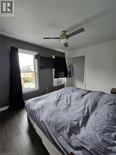 Bedroom featuring dark wood finished floors, a ceiling fan, a closet, and cooling unit - 253 Mary Street, Hamilton, ON - Indoor Photo Showing Bedroom