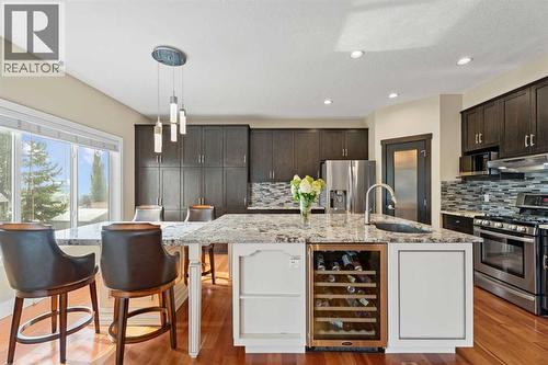 On clear days, you can spot the mountains and foothills from the kitchen window - 113 Aspen Stone Place Sw, Calgary, AB - Indoor Photo Showing Kitchen With Upgraded Kitchen