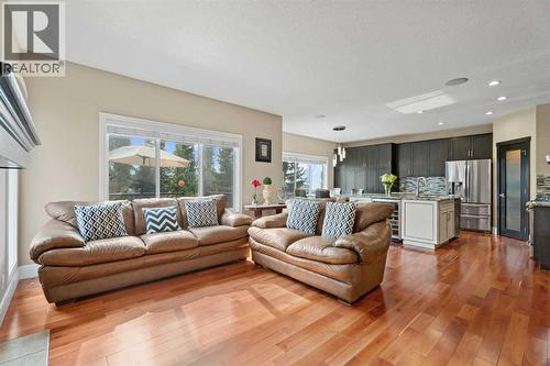 The living room/dining room/kitchen are nicely separated from the office - 113 Aspen Stone Place Sw, Calgary, AB - Indoor Photo Showing Living Room