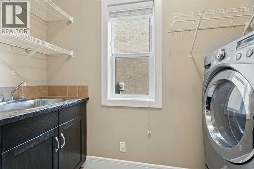 The laundry room has a sink  as well - 113 Aspen Stone Place Sw, Calgary, AB - Indoor Photo Showing Laundry Room