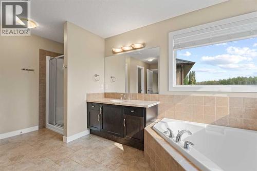 Dual sinks, a soaker tub, separate shower and closet - 113 Aspen Stone Place Sw, Calgary, AB - Indoor Photo Showing Bathroom