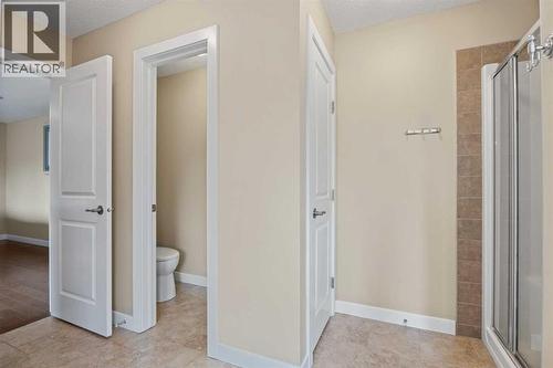 The toilet has its own private room - 113 Aspen Stone Place Sw, Calgary, AB - Indoor