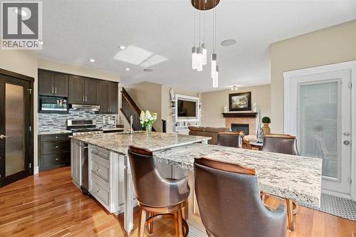 The custom granite table can be placed to connect to the island or be used as a standalone table - 113 Aspen Stone Place Sw, Calgary, AB - Indoor